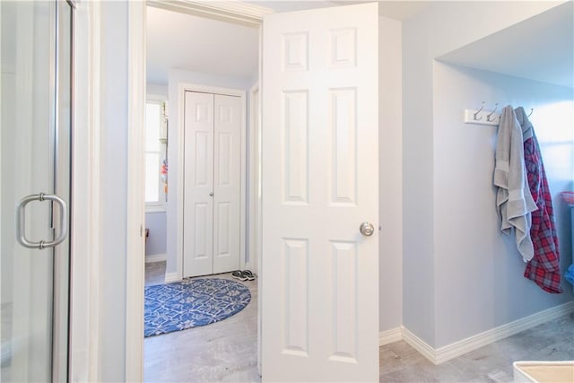 bathroom featuring a shower with shower door