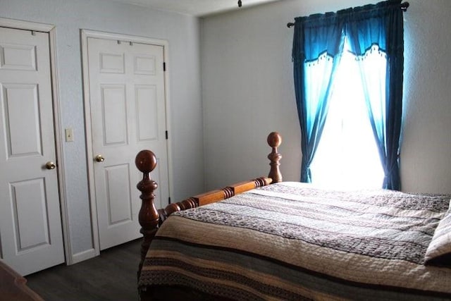 bedroom with dark wood-type flooring