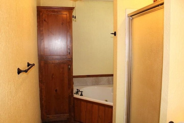 bathroom featuring plus walk in shower