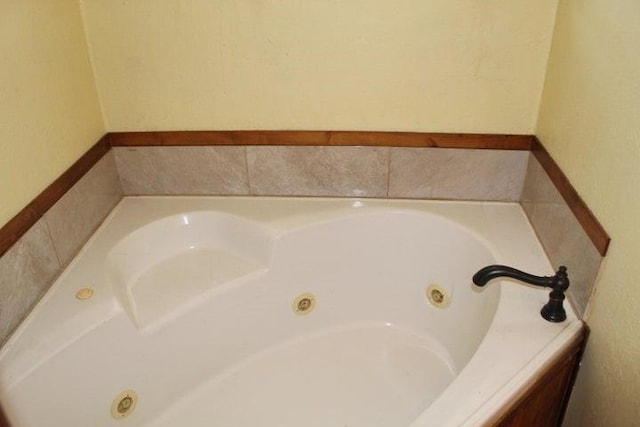 bathroom with tiled bath