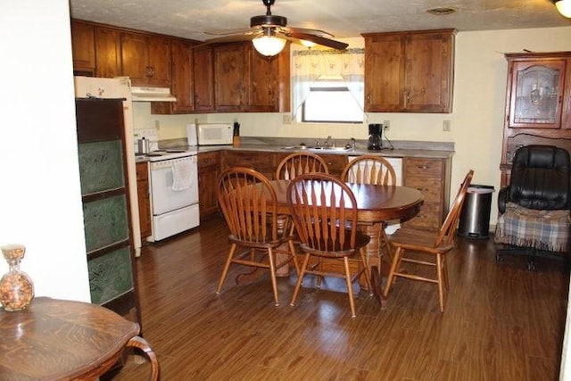 kitchen featuring white appliances, dark wood-type flooring, sink, ceiling fan, and a textured ceiling