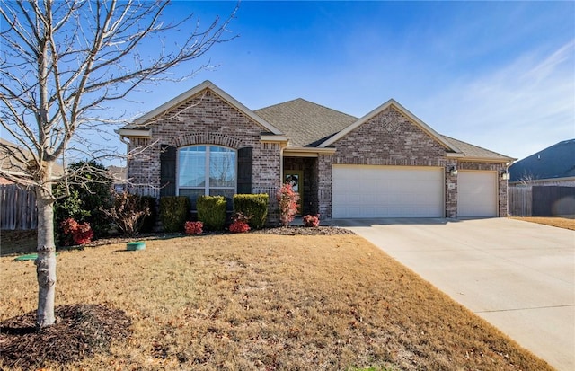 view of front of property with a front lawn and a garage