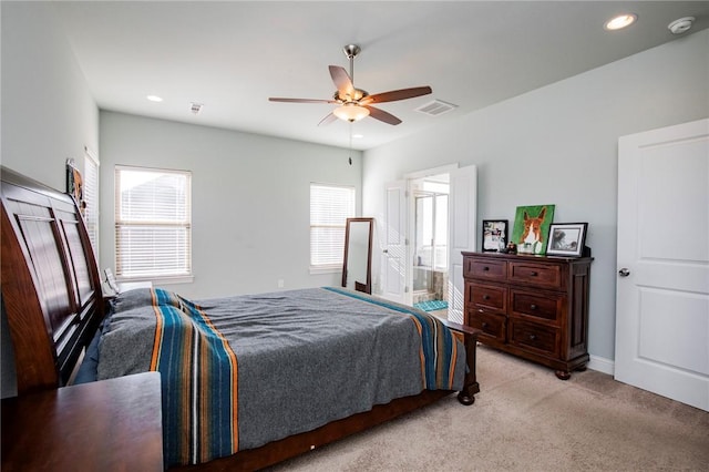 carpeted bedroom with connected bathroom and ceiling fan