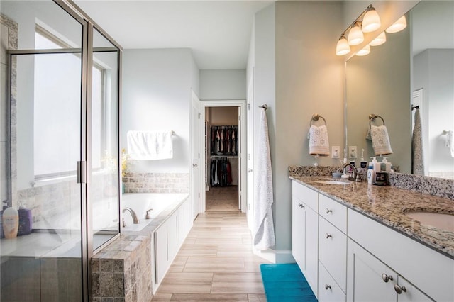 bathroom with independent shower and bath and vanity