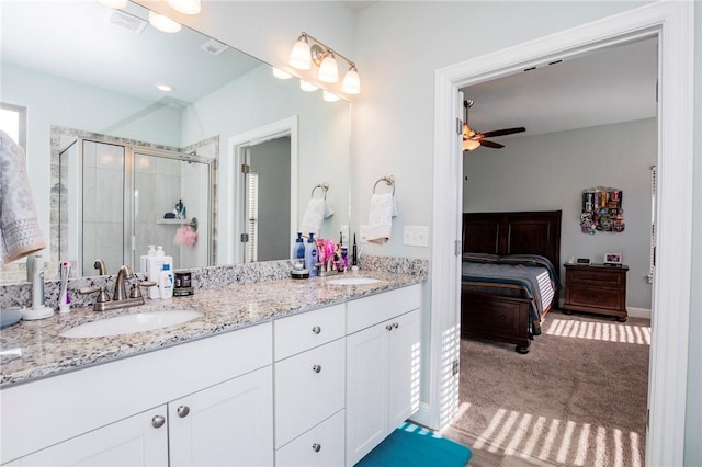 bathroom featuring ceiling fan, walk in shower, and vanity