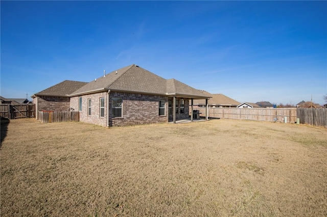 back of house with a lawn