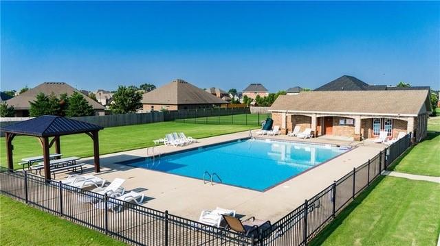 view of swimming pool featuring an outbuilding, a patio, a yard, and a gazebo