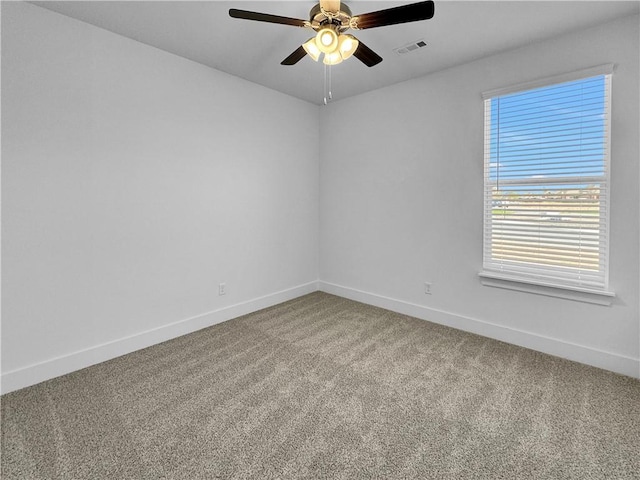 carpeted spare room with ceiling fan