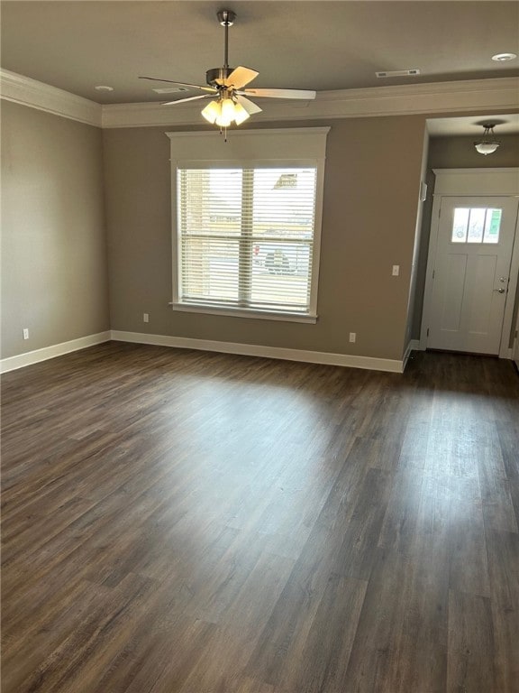 interior space featuring ornamental molding, ceiling fan, and dark wood-type flooring