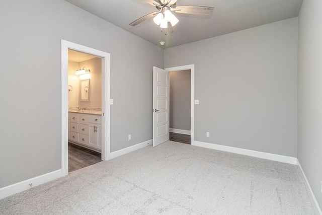 unfurnished bedroom with light carpet, connected bathroom, and ceiling fan