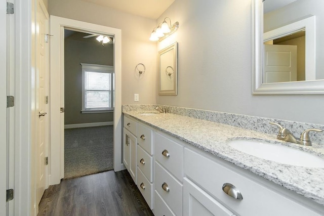 bathroom with hardwood / wood-style flooring, vanity, and ceiling fan