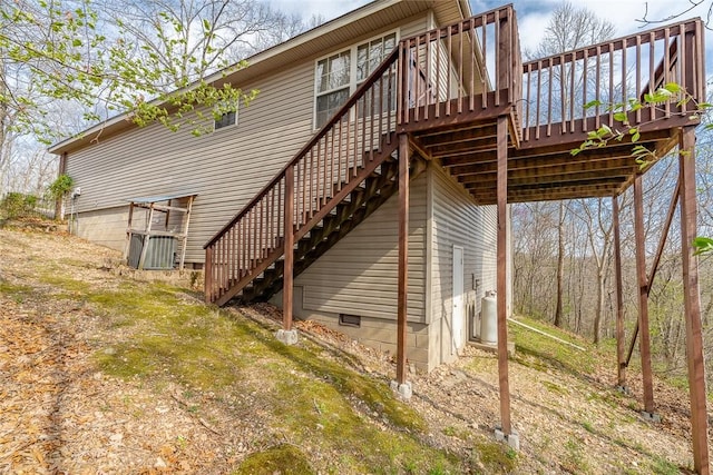 back of house featuring stairway and a deck