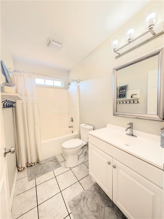 full bath with visible vents, toilet, tile patterned floors, shower / bathtub combination with curtain, and vanity