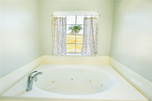 bathroom with a tub to relax in