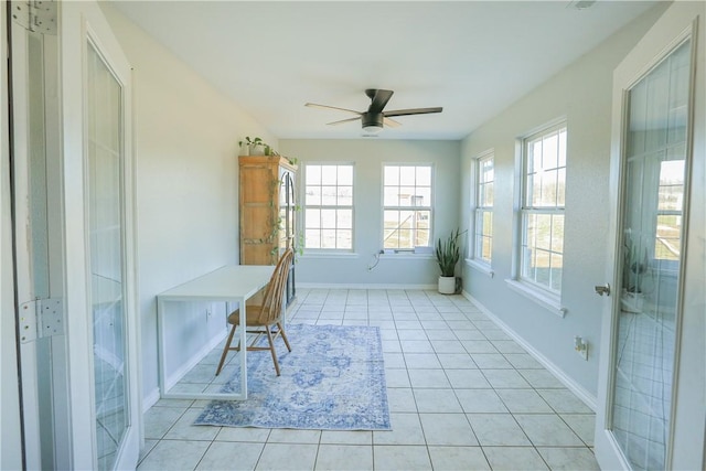 unfurnished office with light tile patterned floors and ceiling fan