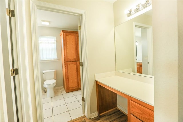 bathroom featuring tile patterned floors, vanity, and toilet