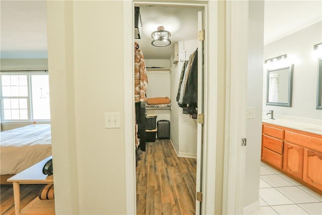 corridor featuring light hardwood / wood-style flooring and sink