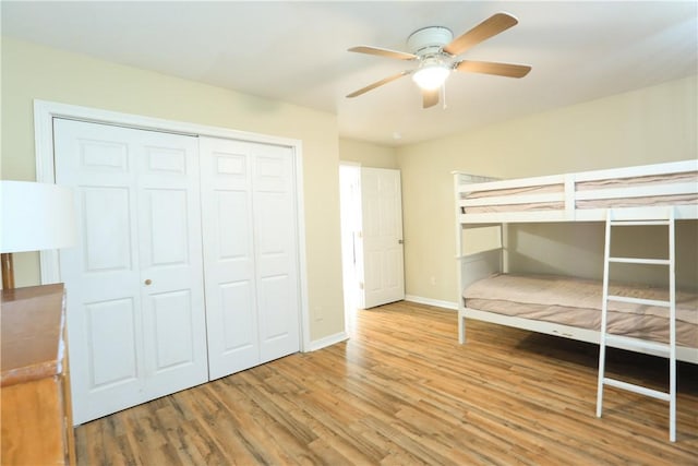 unfurnished bedroom with hardwood / wood-style flooring, a closet, and ceiling fan