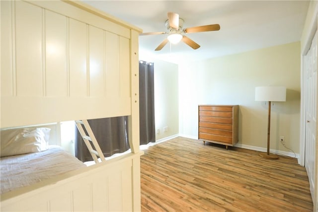 unfurnished bedroom featuring ceiling fan and hardwood / wood-style flooring