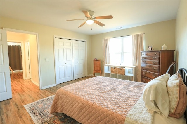 bedroom with ceiling fan, a closet, and light wood-type flooring