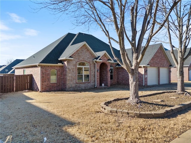 view of front of home with a garage and a front lawn