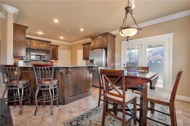 kitchen featuring kitchen peninsula, stainless steel appliances, plenty of natural light, and crown molding