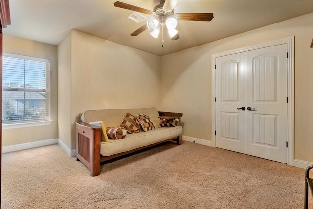 sitting room with light colored carpet and ceiling fan