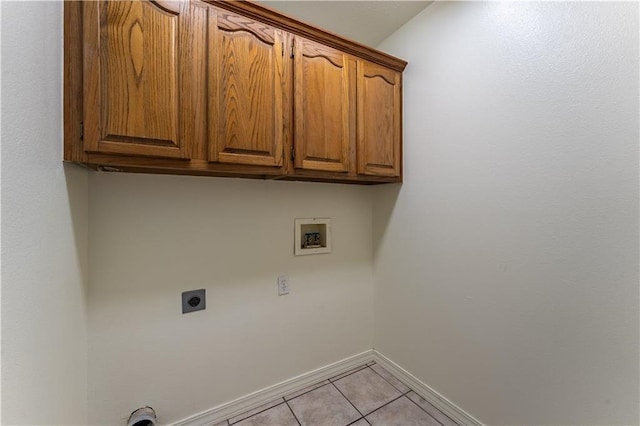 laundry room with hookup for a washing machine, cabinets, hookup for an electric dryer, and light tile patterned floors