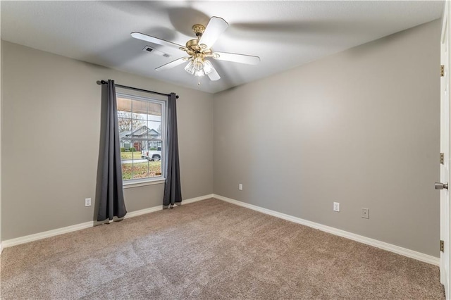 empty room with ceiling fan and carpet