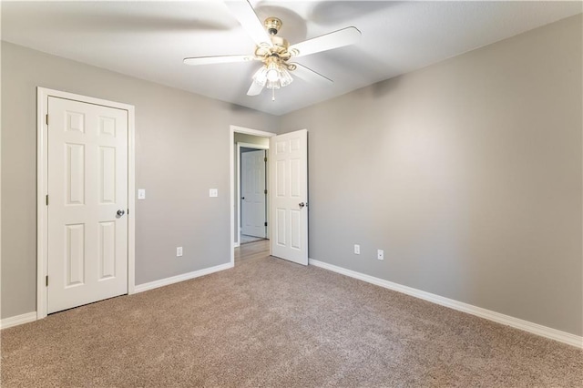 unfurnished bedroom featuring ceiling fan and carpet flooring