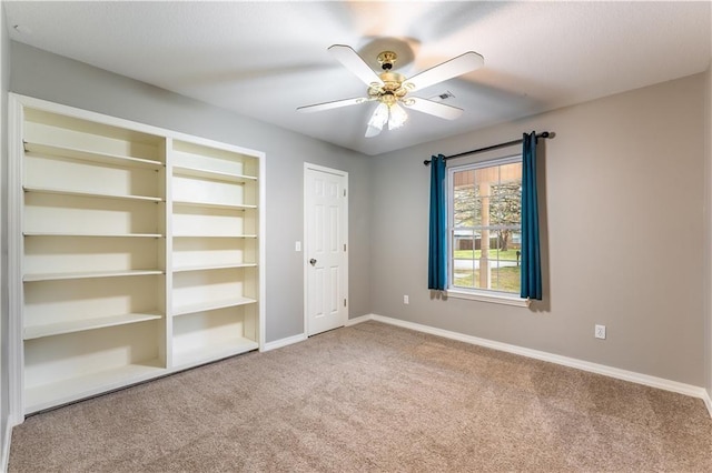 unfurnished bedroom with ceiling fan and carpet