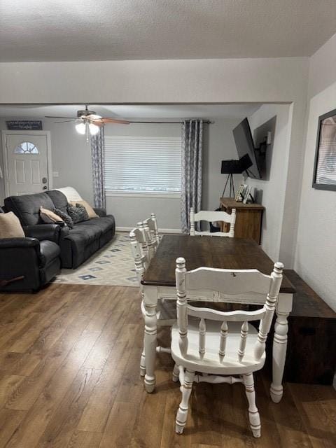 dining area featuring hardwood / wood-style floors, a textured ceiling, and ceiling fan