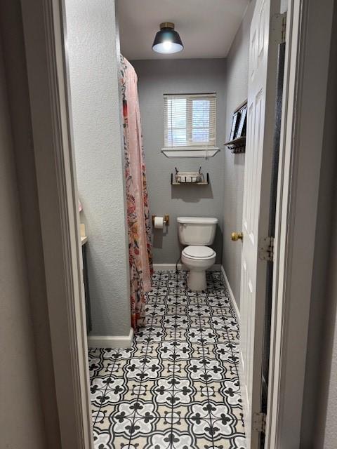 bathroom with tile patterned floors and toilet