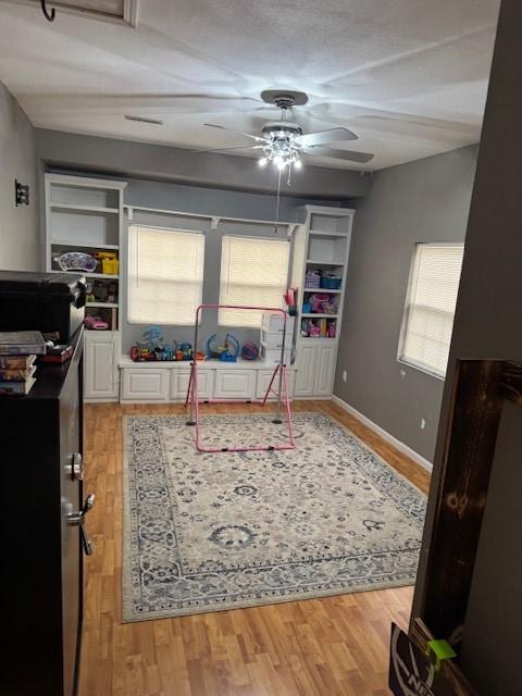 bedroom with light hardwood / wood-style floors and ceiling fan