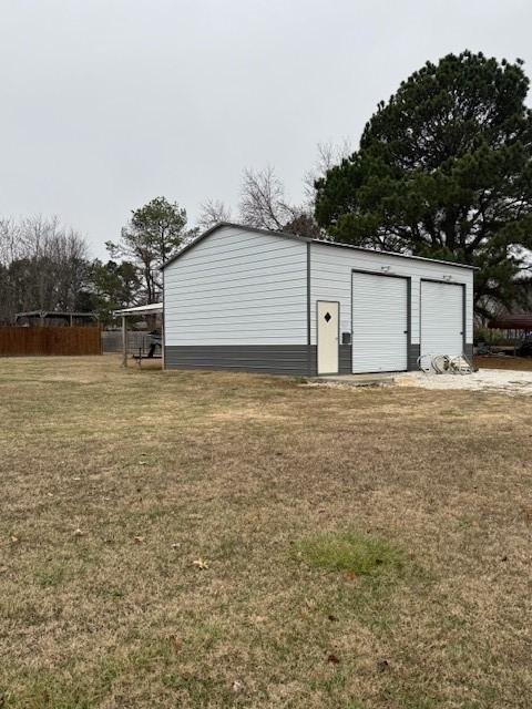 view of outbuilding with a garage and a yard