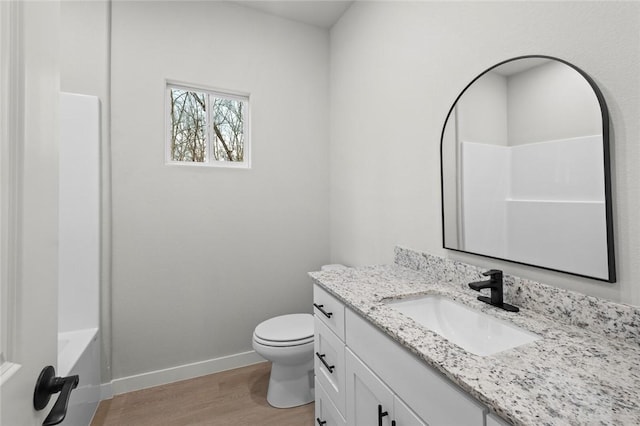 full bathroom with hardwood / wood-style floors, vanity, toilet, and tub / shower combination