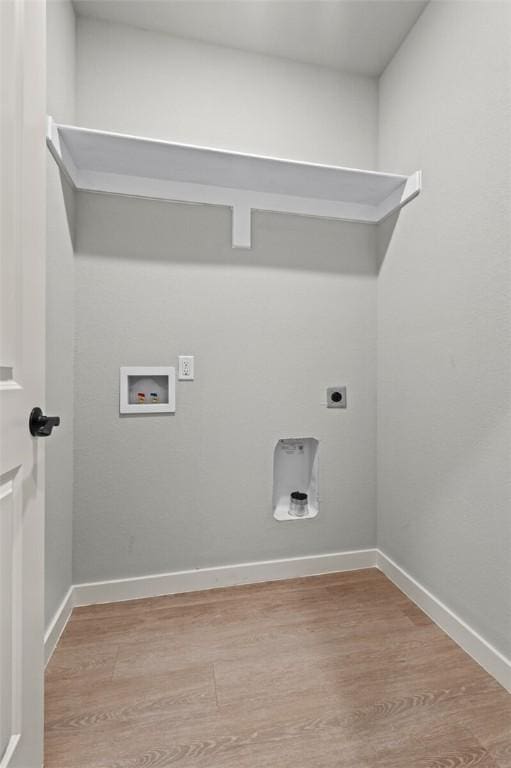 clothes washing area with hookup for a washing machine, light hardwood / wood-style flooring, and electric dryer hookup