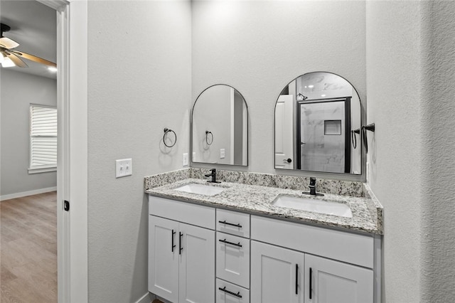 bathroom featuring an enclosed shower, hardwood / wood-style floors, vanity, and ceiling fan