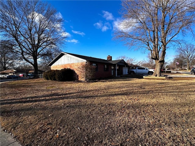 view of side of home with a yard