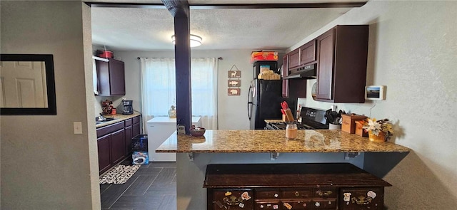 kitchen featuring a kitchen breakfast bar, stove, kitchen peninsula, and light stone counters