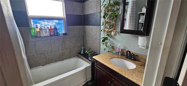 bathroom with a bathing tub and vanity