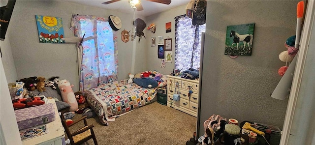 bedroom featuring ceiling fan and carpet