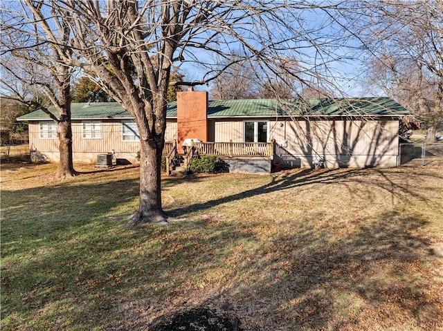 exterior space with a wooden deck and a yard