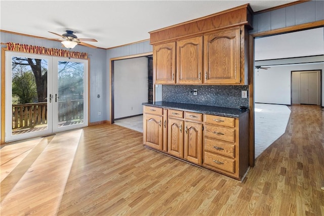 kitchen with ceiling fan, light hardwood / wood-style floors, ornamental molding, and french doors