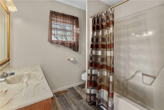 full bathroom featuring vanity, shower / bath combination with curtain, and toilet