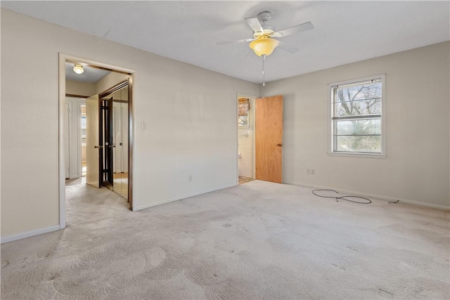 carpeted spare room featuring ceiling fan