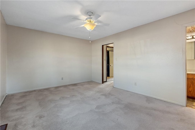 spare room featuring ceiling fan and light carpet