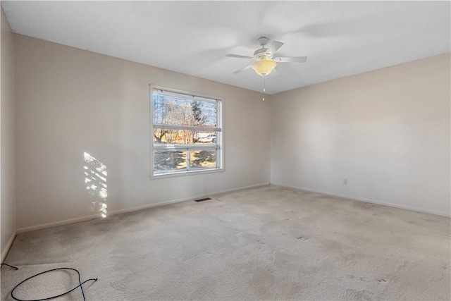 carpeted spare room with ceiling fan