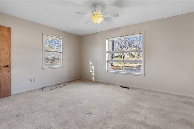 unfurnished room featuring ceiling fan and light colored carpet