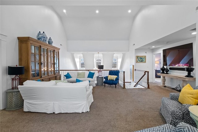 carpeted living room featuring high vaulted ceiling